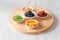 Dried fruits, with kiwi slices, strawberry, dried mango slices, orange, and prunes in white bowls on wooden plate. Organic healsy