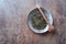 Dried Green Tea  sencha Leaves on rustic stone Background