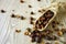 Dried hawthorn fruits in scoop on wooden table