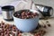 Dried hawthorn hips in a bowl and scattered on a wooden table