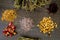 Dried Herbs on gray / grey slate background - chamomile, hibiscus, arnica,  elder flower, rose bud and rosemary