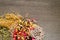 Dried Herbs on gray / grey slate background -chamomile, hibiscus, arnica,  elder flower, rose bud and rosemary