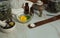 Dried herbs, small bottles of essential oils, mortar and pestle, massage herbal bag, fragrant stick on a marble background.