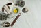 Dried herbs, small bottles of essential oils, mortar and pestle, massage herbal bag, fragrant stick on a marble background.