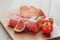 Dried jamon slices with figs on wood table