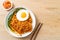 Dried Korean spicy instant noodles with fried egg