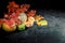 Dried leaves, pumpkins on dark background