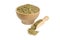Dried leaves of yerba mate tea in wooden bowl and scoop isolated on white background. Nutrition. Traditional tea in South-America