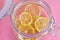 Dried lemons and limes in an electric dryer in a glass jar