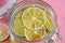 Dried lemons and limes in an electric dryer in a glass jar