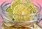 Dried lemons and limes in an electric dryer in a glass jar