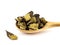 Dried licorice or liquorice roots lie in a wooden spoon on a white background