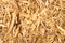 Dried licorice root is grated as a background close-up