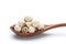 Dried lotus seeds in a wooden spoon