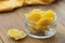 Dried mango in glass bowl on wooden background, healthy snack, fruit chips