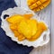 Dried Mango lay on the white plate near the fresh mango