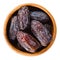 Dried Medjool dates from Morocco in wooden bowl