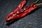 Dried Mexican Red Chile De Arbol Pepper on black natural stone. Capsicum annuum.