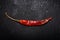 Dried Mexican Red Chile De Arbol Pepper on black natural stone. Capsicum annuum.