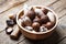 Dried mixed nuts in wooden bowl closeup