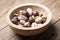 Dried mixed nuts in wooden bowl closeup