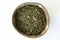 Dried Nettles in a Wooden Bowl on a Beige Background View from Above. Healthful Natural Tea.