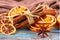 Dried oranges, star anise, cinnamon sticks on blue wooden background - Christmas composition, still life