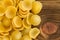 Dried orecchiette pasta on wood with copy space