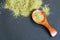 Dried oregano herbs in wooden spoon. Natural light. Selective focus. Close up on a black background. Top view, flat lay