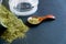 Dried oregano herbs in wooden spoon. Natural light. Selective focus. Close up on a black background. Top view, flat lay. copy spac