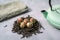 Dried Organic Black Tea Leaves and aromatic green tea flowers ball on gray Background. Composition with Iron teapot and