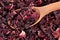 Dried petals of hibiscus in a wooden spoon