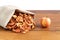 Dried pieces of apples in rough linen fabric lying on a wooden table