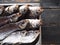 Dried privately, in the fresh air, salted large bream, in a metal container.Close up.River fish