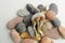 Dried Psilocybe Cubensis Psilocybin Mushrooms and sea pebbles on white background