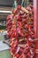 Dried red hot chilly peppers hanging on the market