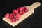 Dried red raspberry on grey stone