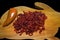 Dried red sweet pepper on antique wood rabbit shaped cutting board.