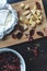 Dried red tomatoes arranged with italian cheese Camembert on dark background. Top view. Light sneak meal.