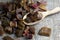 Dried rhubarb candied fruits in a wooden spoon. Candied rhubarb on a canvas fabric background. Dry rhubarb close - up macro