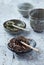 Dried Rooibos and Green Tea Leaves on Bright Stone Background