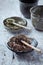 Dried Rooibos and green Tea Leaves on Bright Stone Background.