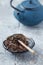 Dried Rooibos Leaves on Bright Stone Background.