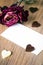 Dried rose, blank business card and chocolate hearts