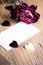 Dried rose, blank business card and chocolate hearts