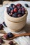 Dried rose hip berries in wood bowl, spoon, scattered on linen towel, health concept, natural medicine