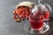 Dried rose hip glass cup of herbal tea medicinal plants with rosehip fruits in burlap sack and glass teapot on black rustic table