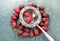 Dried rosehips ,tea strainer,on wooden background