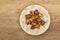 Dried roses on plate, wood