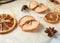 dried round slices of lemon and apple as well as star anise on a blue background